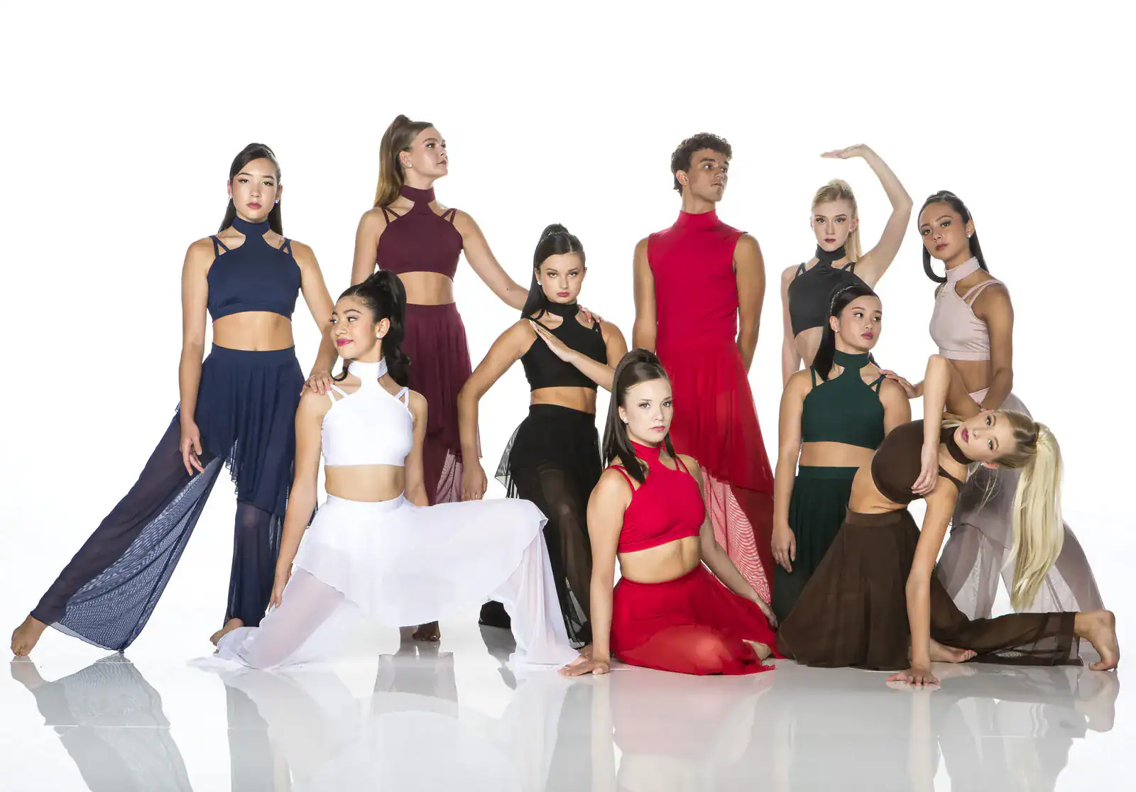 Diverse dance group posing in colorful contemporary costumes