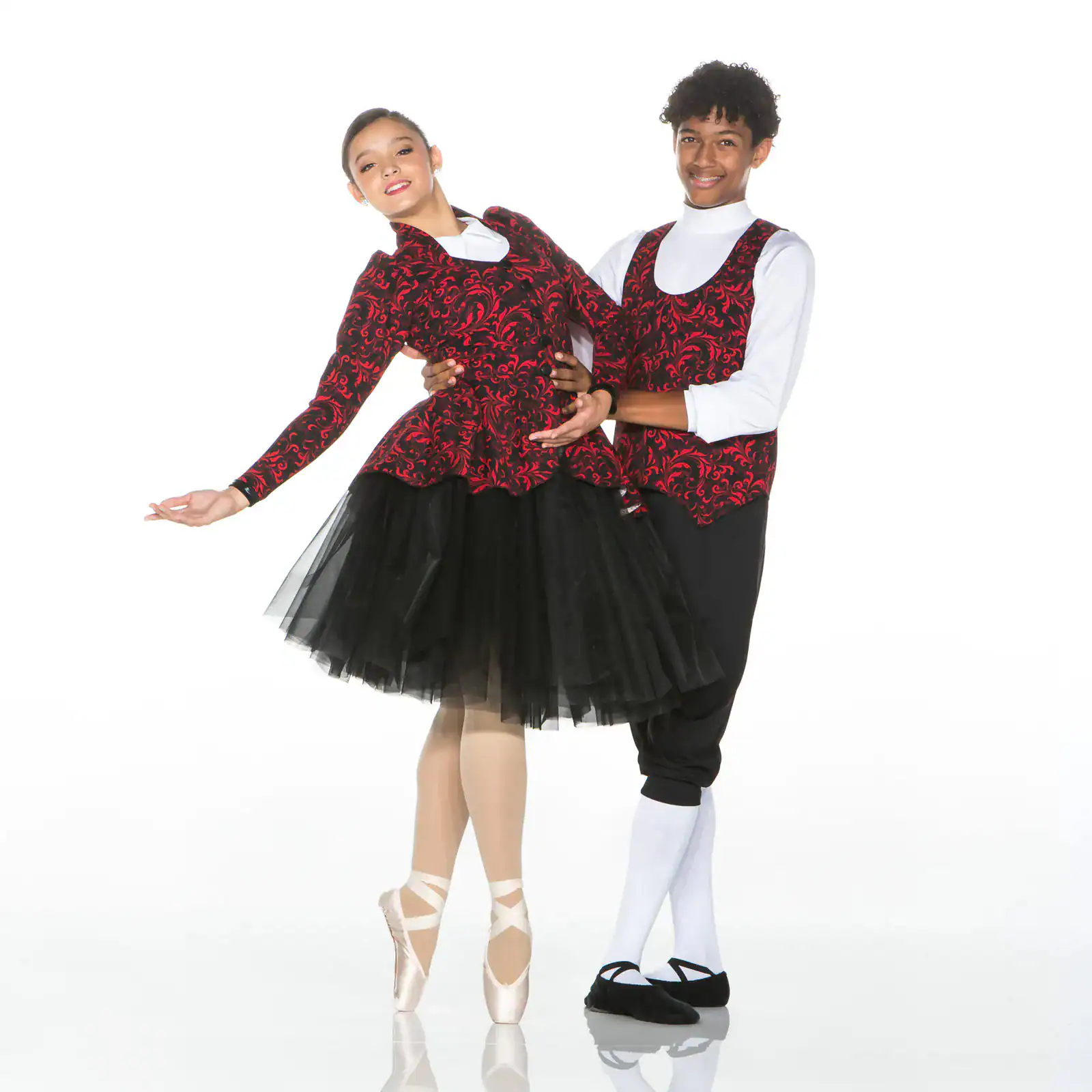 Two ballet dancers posing in matching red and black costumes