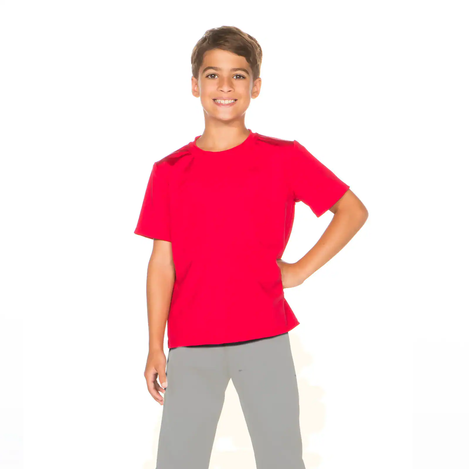 Smiling boy wearing a red shirt and gray pants