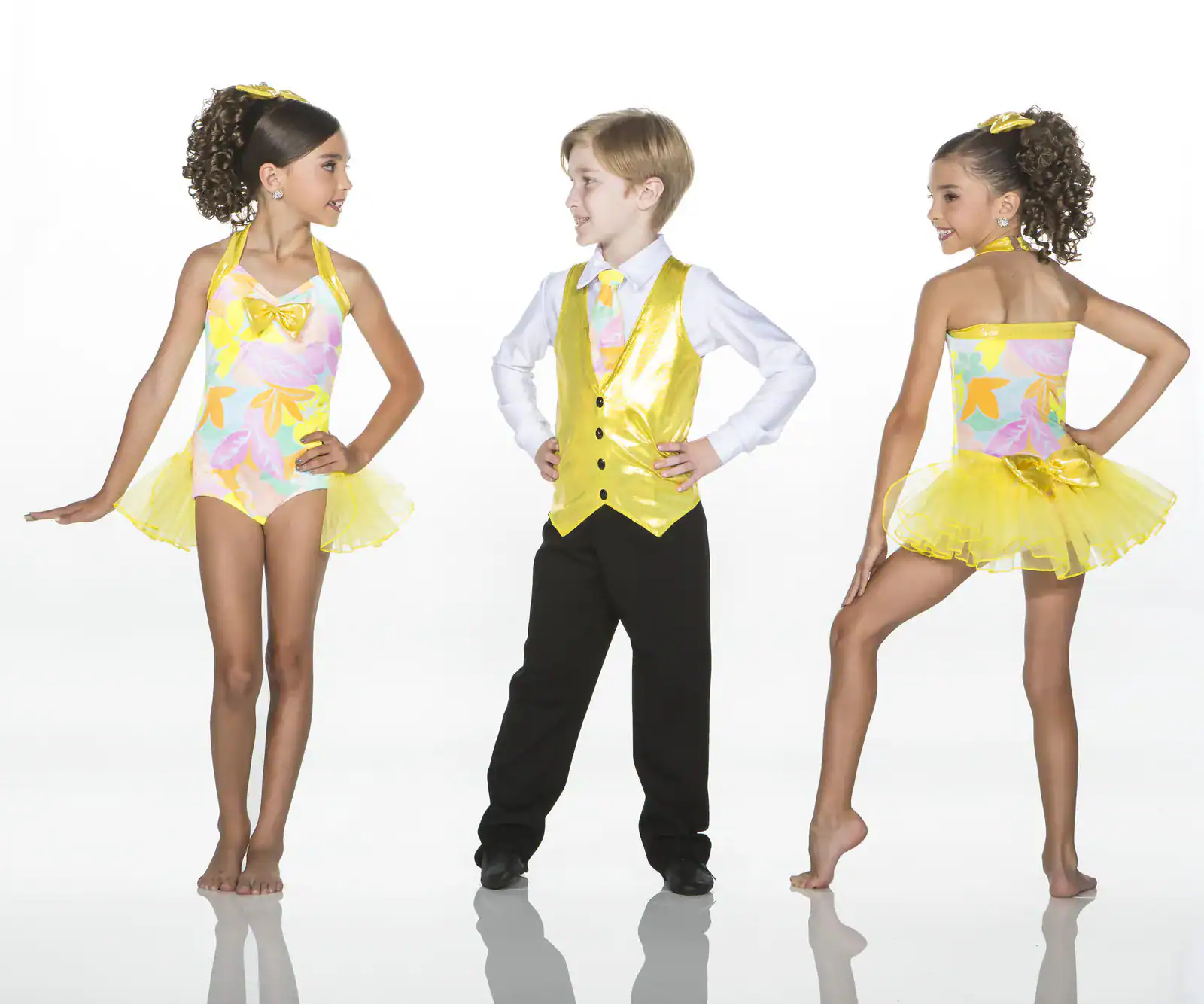 Children wearing colorful yellow and floral dance costumes
