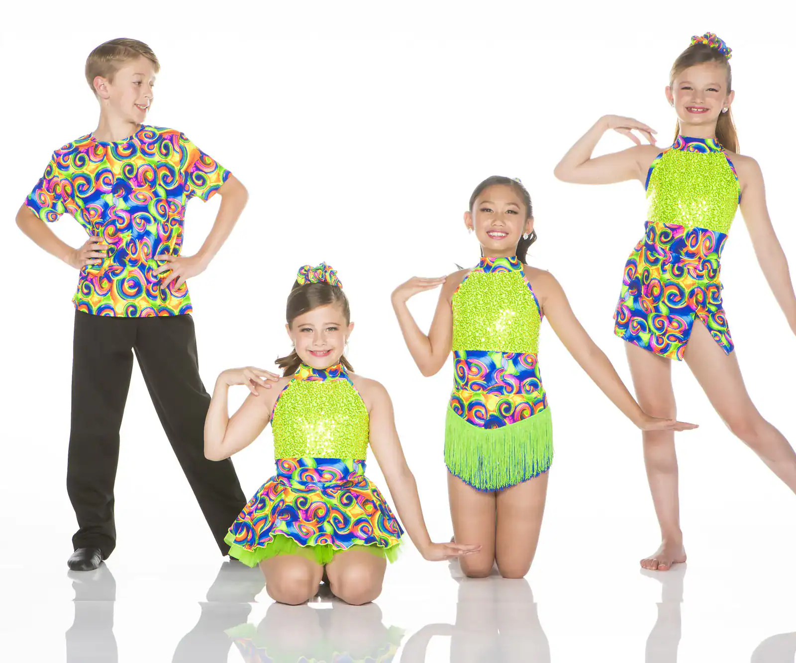 Four young dancers in colorful matching costumes pose together.