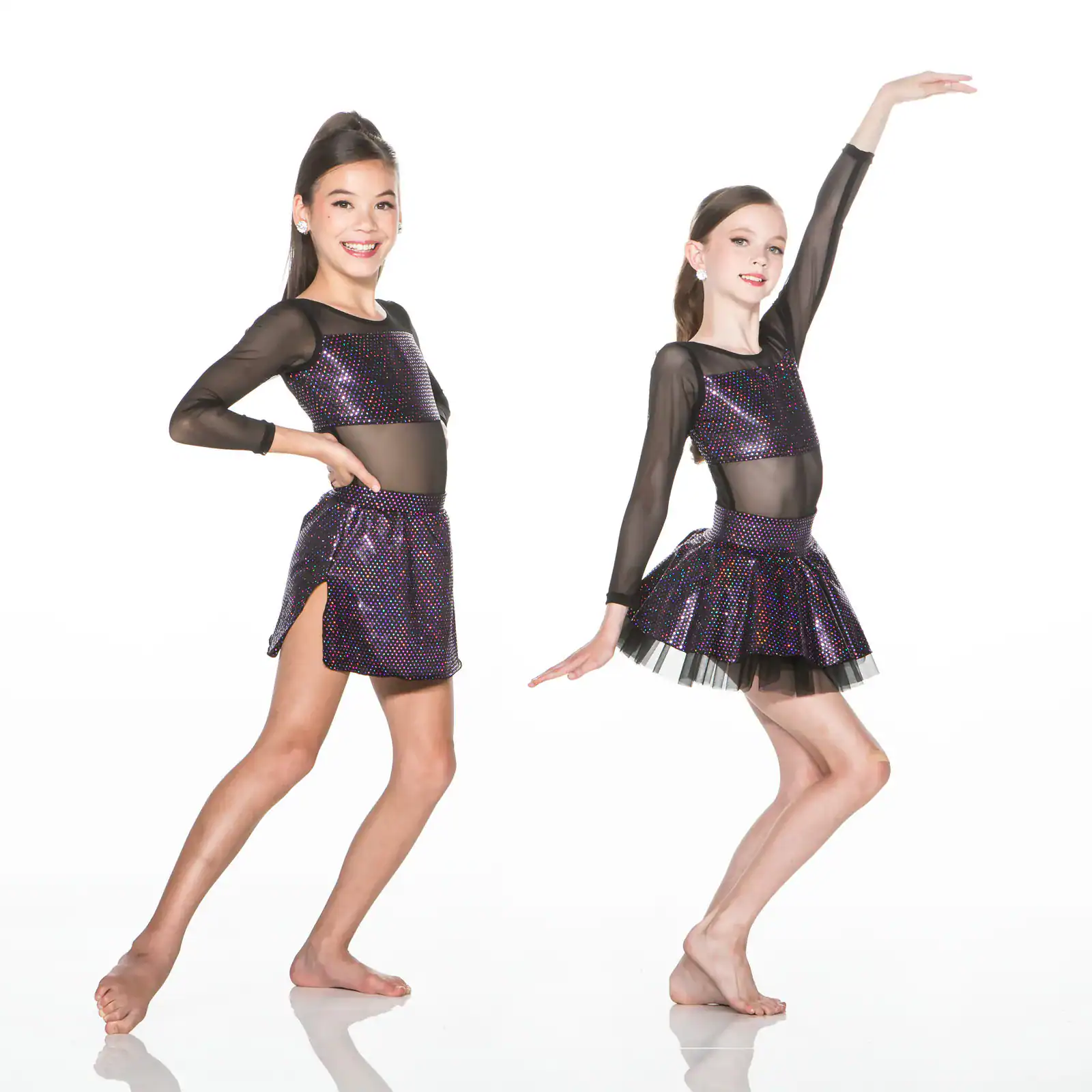 Two young dancers wearing sparkling black costumes pose.