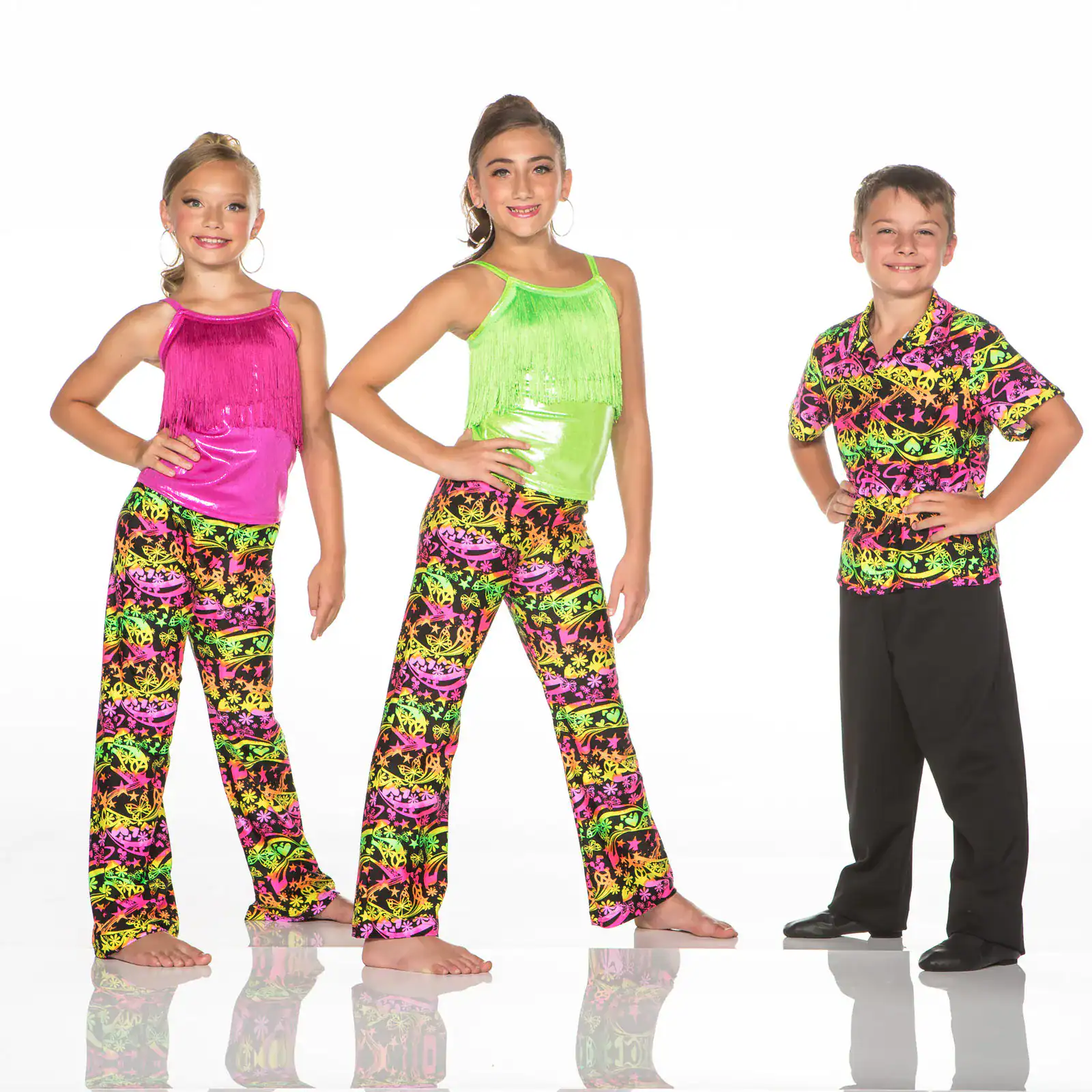Three children model colorful neon dance costumes against white background.