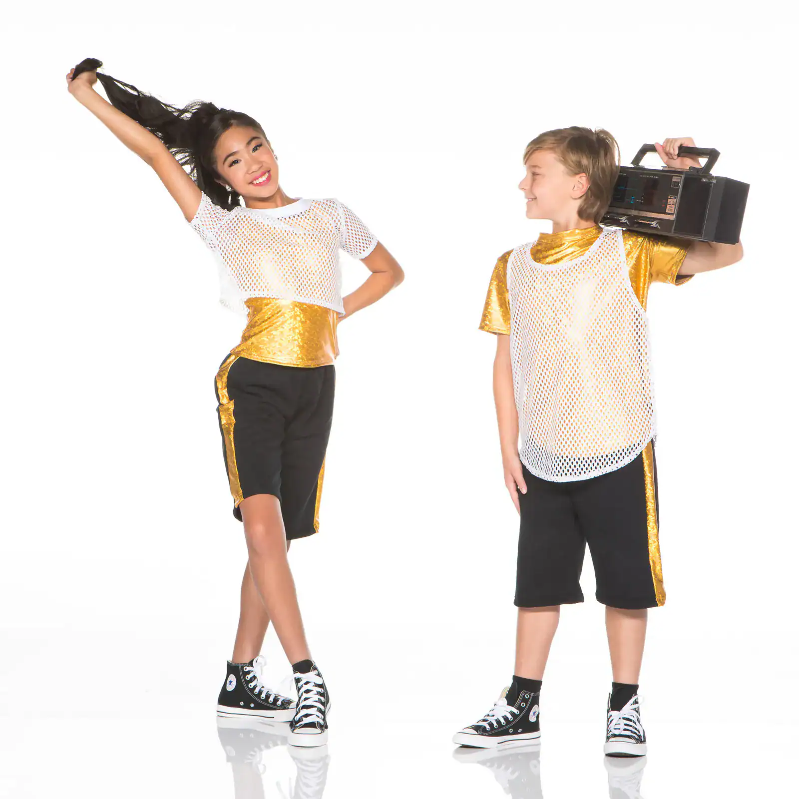 Two children in gold hip-hop outfits, one holding boombox.