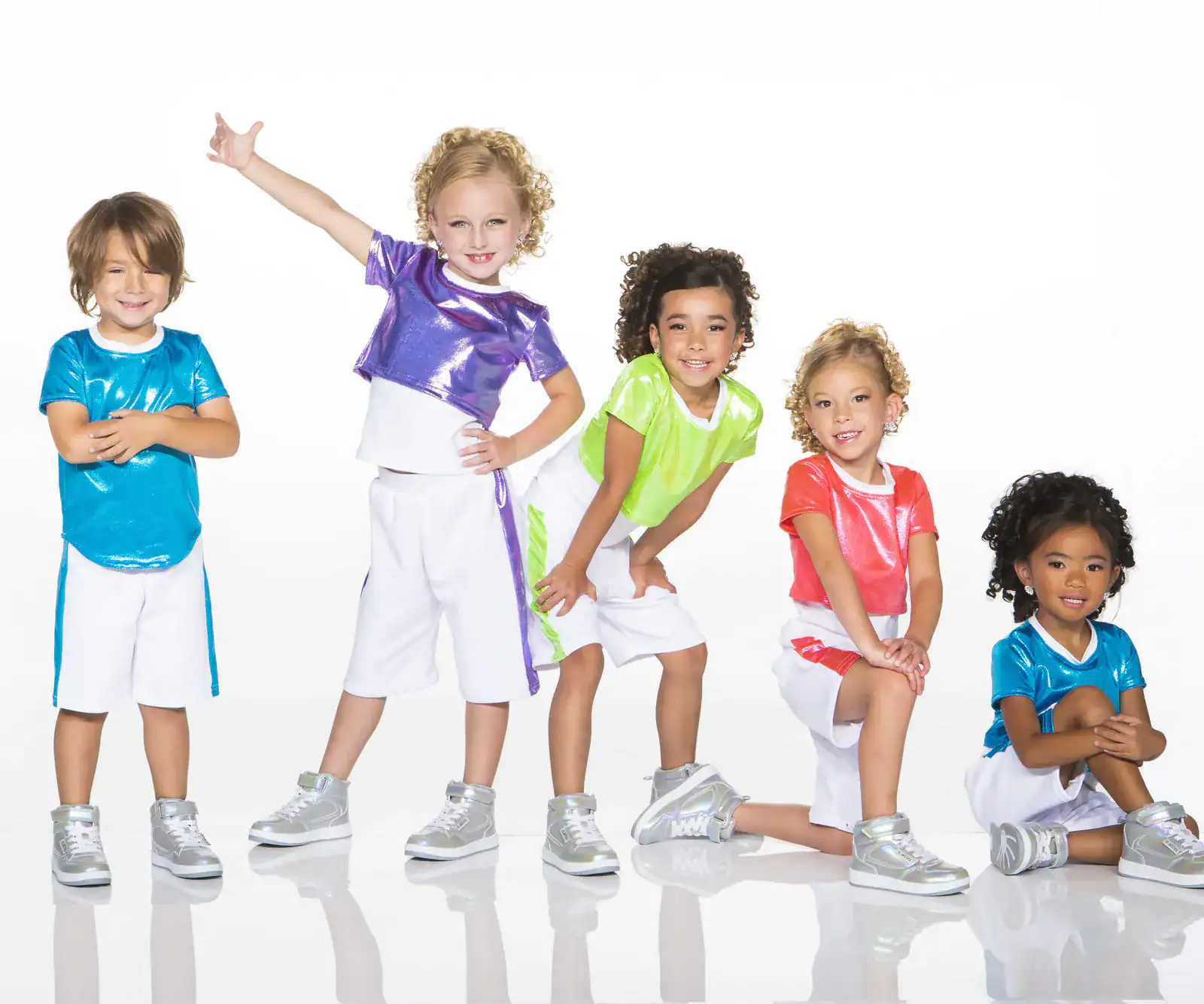 Five children wearing colorful dance outfits and silver sneakers