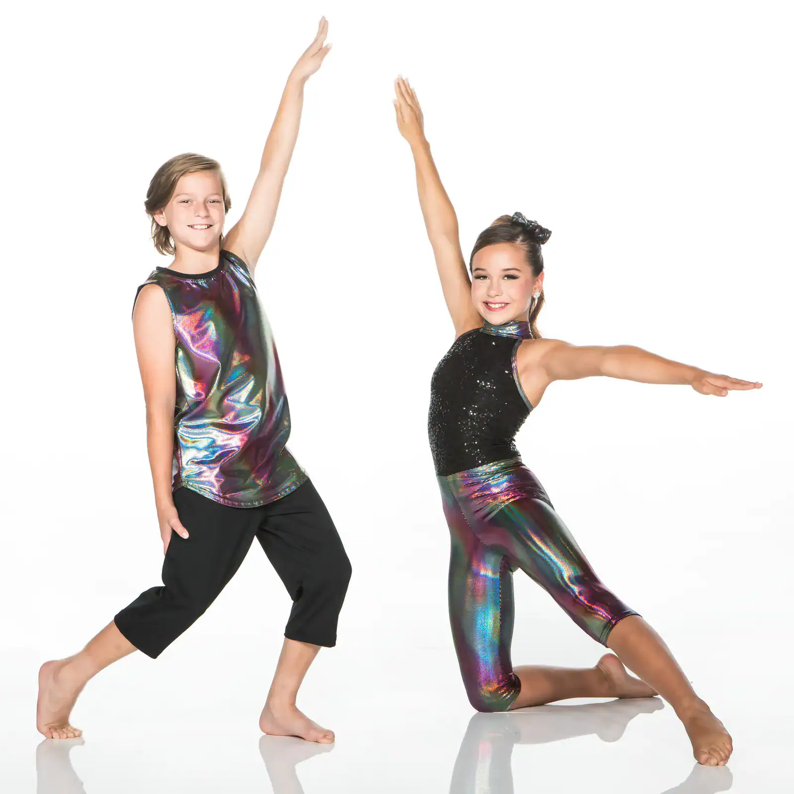 Two young dancers pose in colorful metallic dancewear.