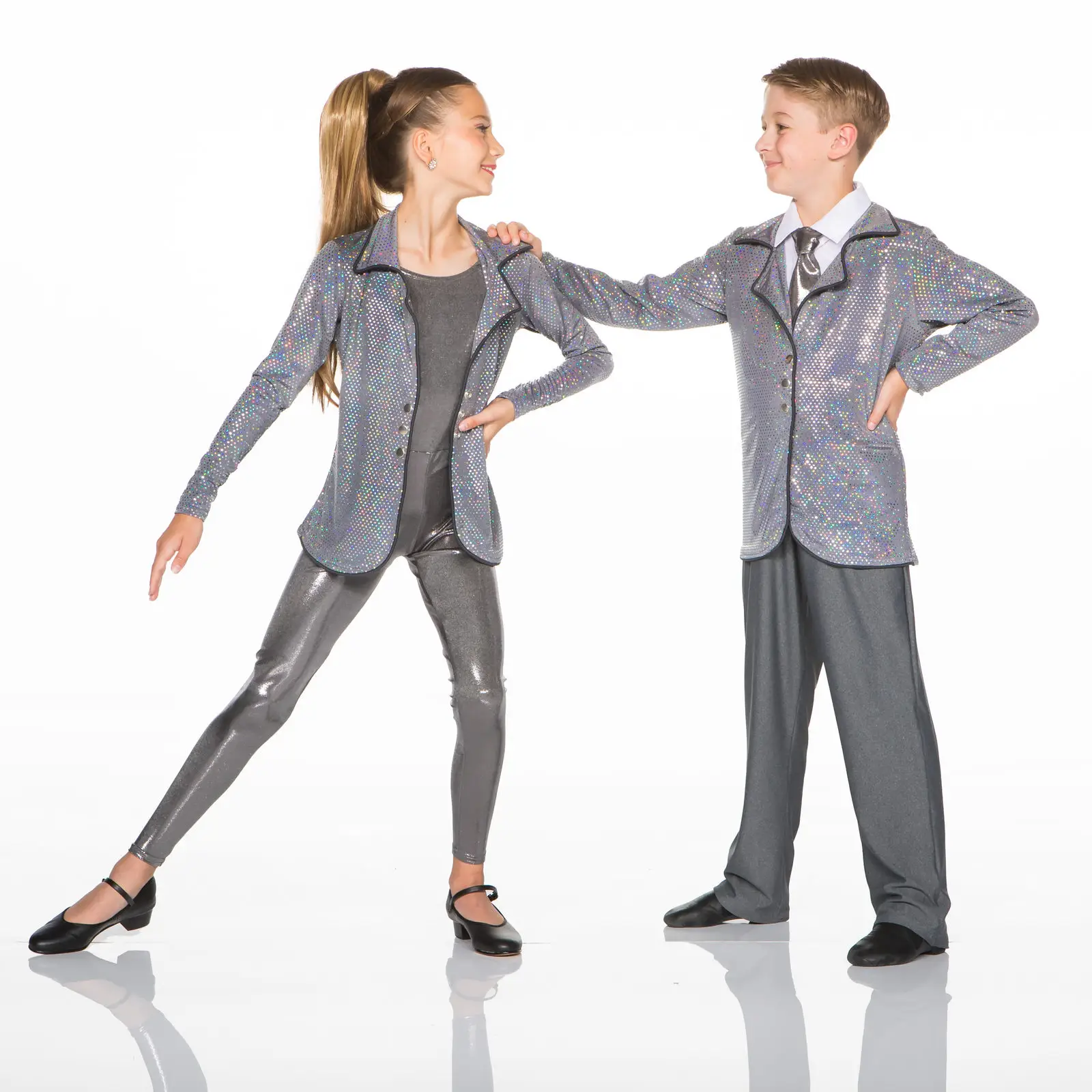 Young dancers wearing matching silver sequined jackets